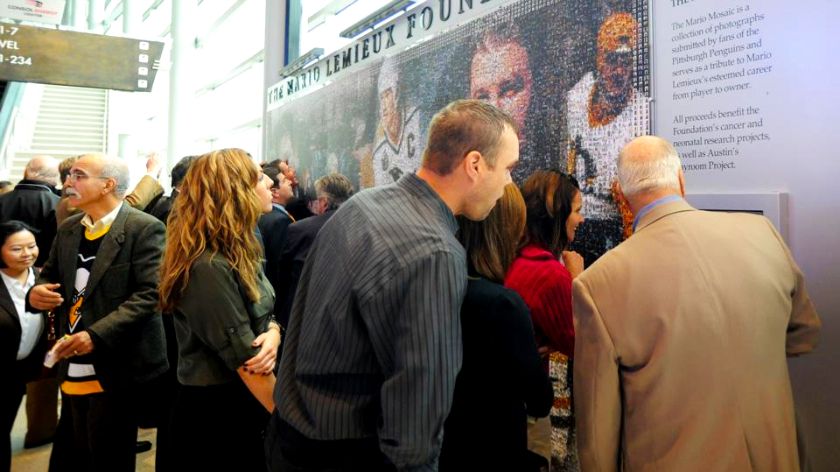 Guests using the onsite kiosk to find their mosaic photo.