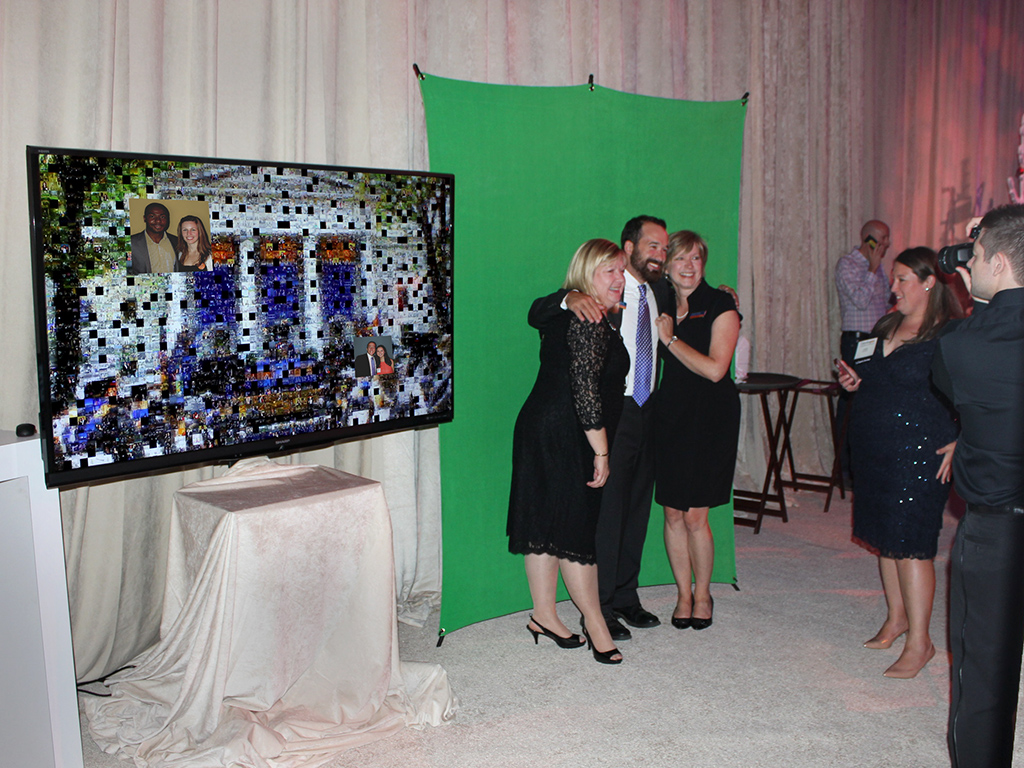 Three guests getting their photo taken by an event tech for the GettysburGreat Fundraiser mosaic