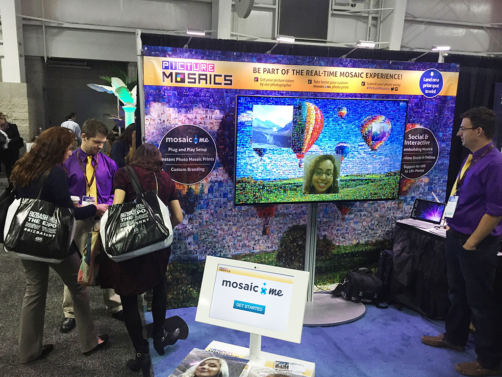 Two women submitting their photo into the interactive digital mosaic