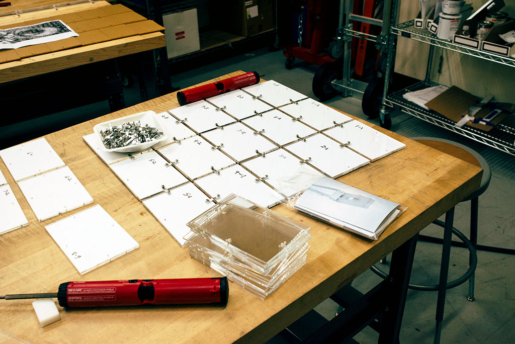 Hardware and supplies to build a photo mosaic laid out on a table