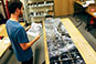 Person looking at pieces of a photo mosaic laid out on a table