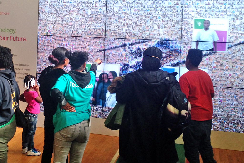 Attendees gathered around the digital mosaic, admiring the display