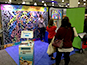 Full booth setup displaying photo mosaic wall, digital mosaic screen, and Mosaic Me kiosk at BizBash Live in New York