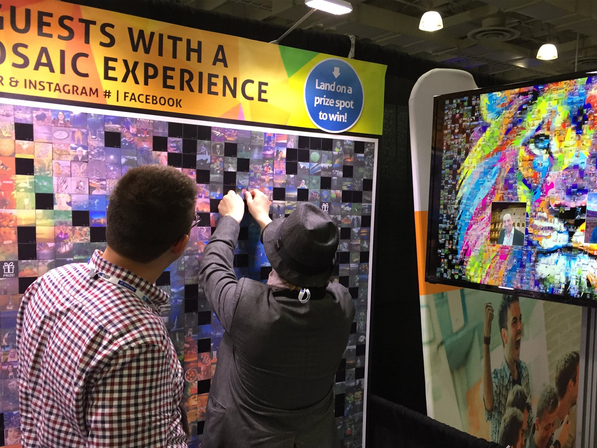 Guest placing their printed photo tile onto the interactive mosaic wall
