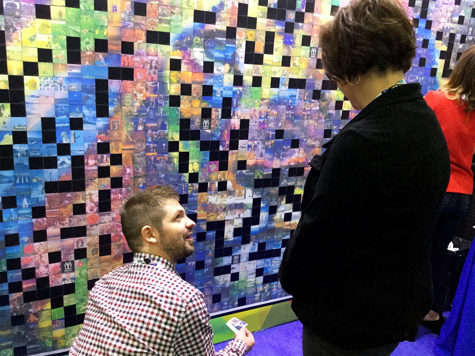 Full event booth setup with mosaic wall, digital mosaic screen, and Mosaic Me kiosk at BizBash Live in New York