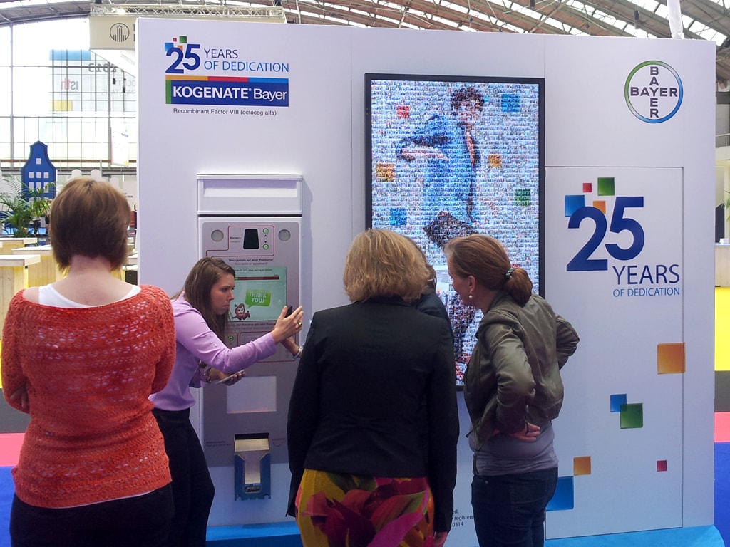 Interactive kiosk allowing attendees to view and interact with the evolving photo mosaic at Bayer's exhibit during the XXIV ISTH Congress
