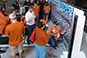 Family participating in the Texas Longhorn Orange-White Spring Game Live Print Mosaic Event by placing their photo in the mosaic