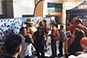 Brand ambassador capturing a guest's photo on a tablet at the Texas Longhorn Orange-White Spring Game Live Print Mosaic Event