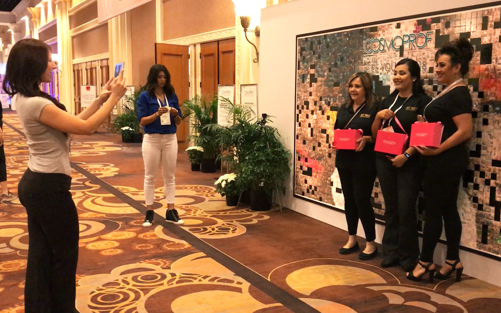 Attendee capturing photo at CosmoProf Las Vegas 2017