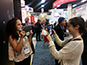 Guests taking photos at the Google booth during the ISTE live print mosaic event