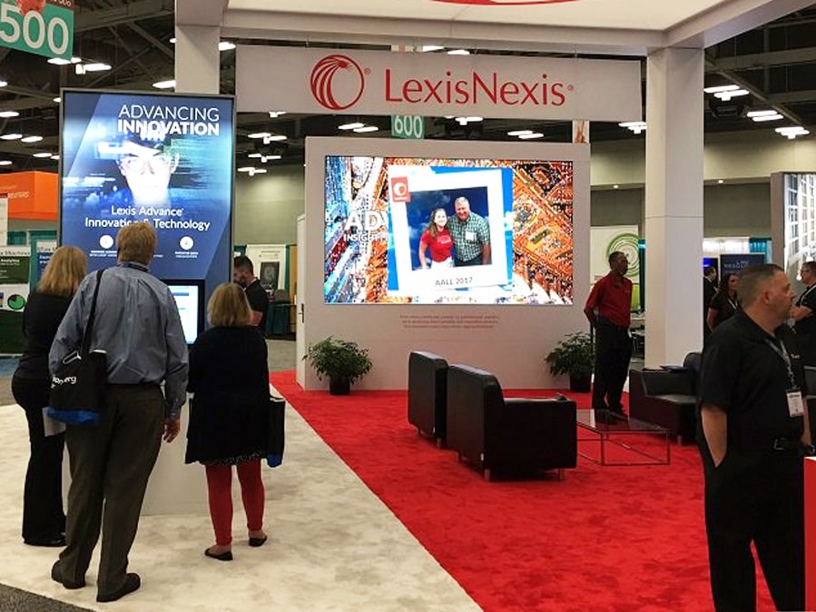 Close-up view of a guest interacting with the digital mosaic screen at the LexisNexis event