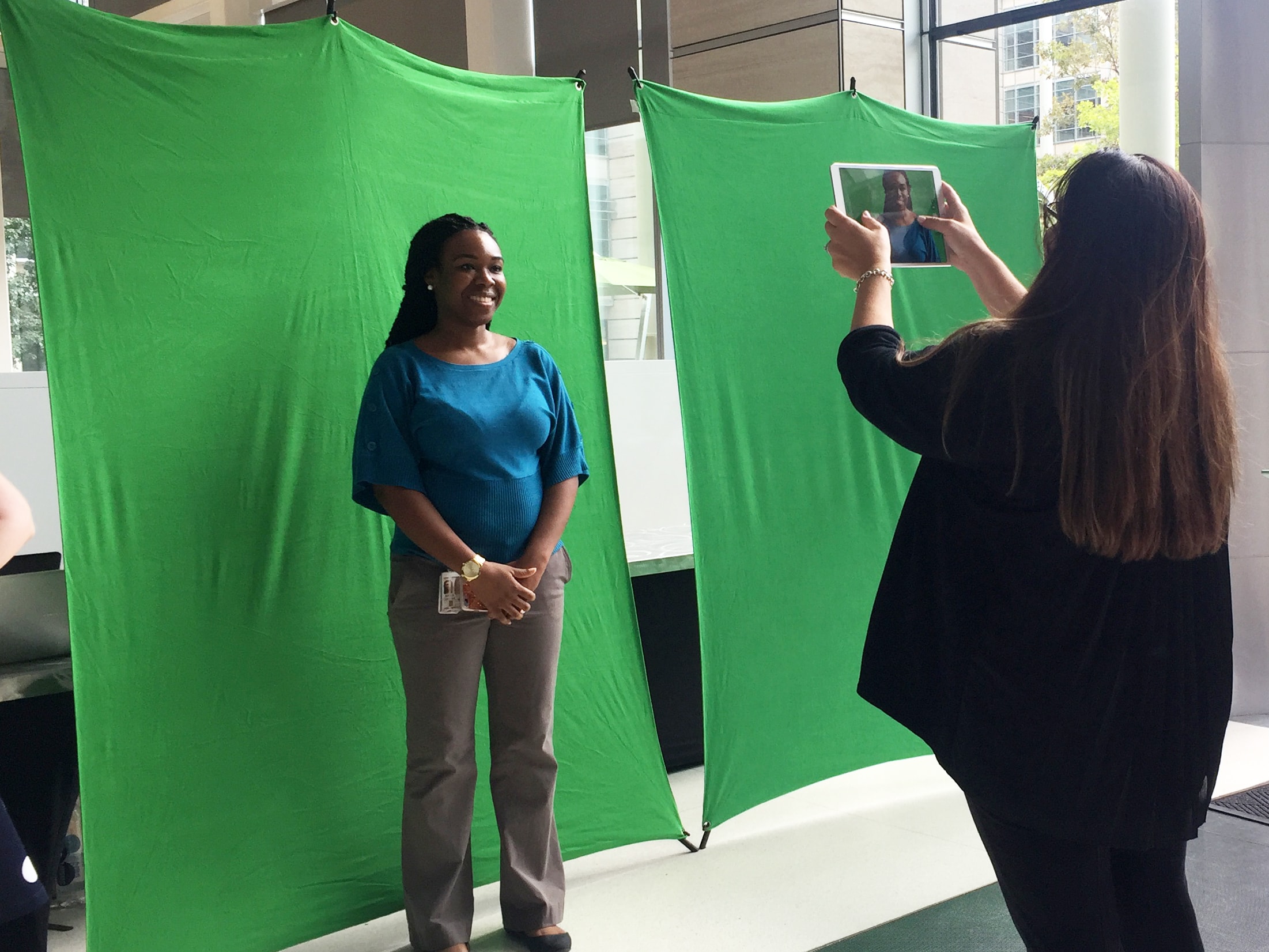 Event technician photographing a guest for inclusion in the live photo mosaic
