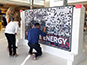 Participants placing their printed photos onto the mosaic wall