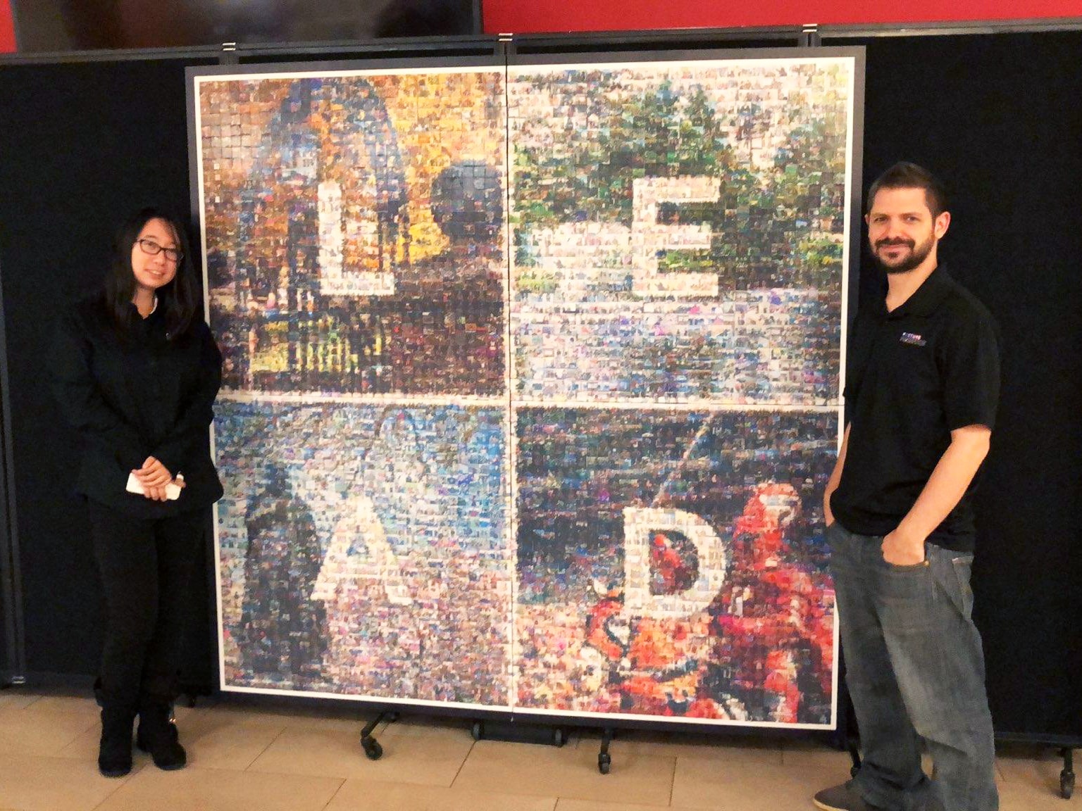 Rutgers LEAD photo mosaic wall with two event technicians standing beside it