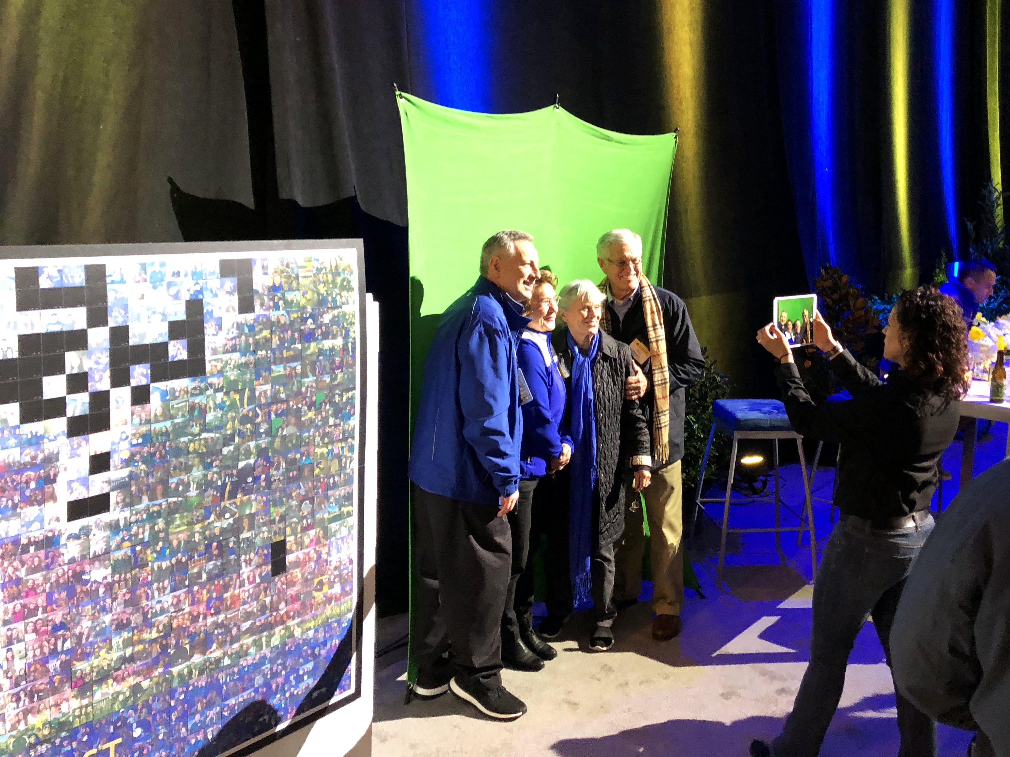 Event technician photographing a group of adults for mosaic participation