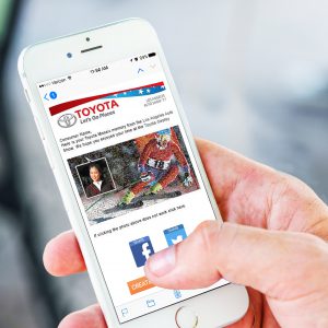 Toyota branded takeaway email shown on iPhone, highlighting guest’s photo placement in mosaic
