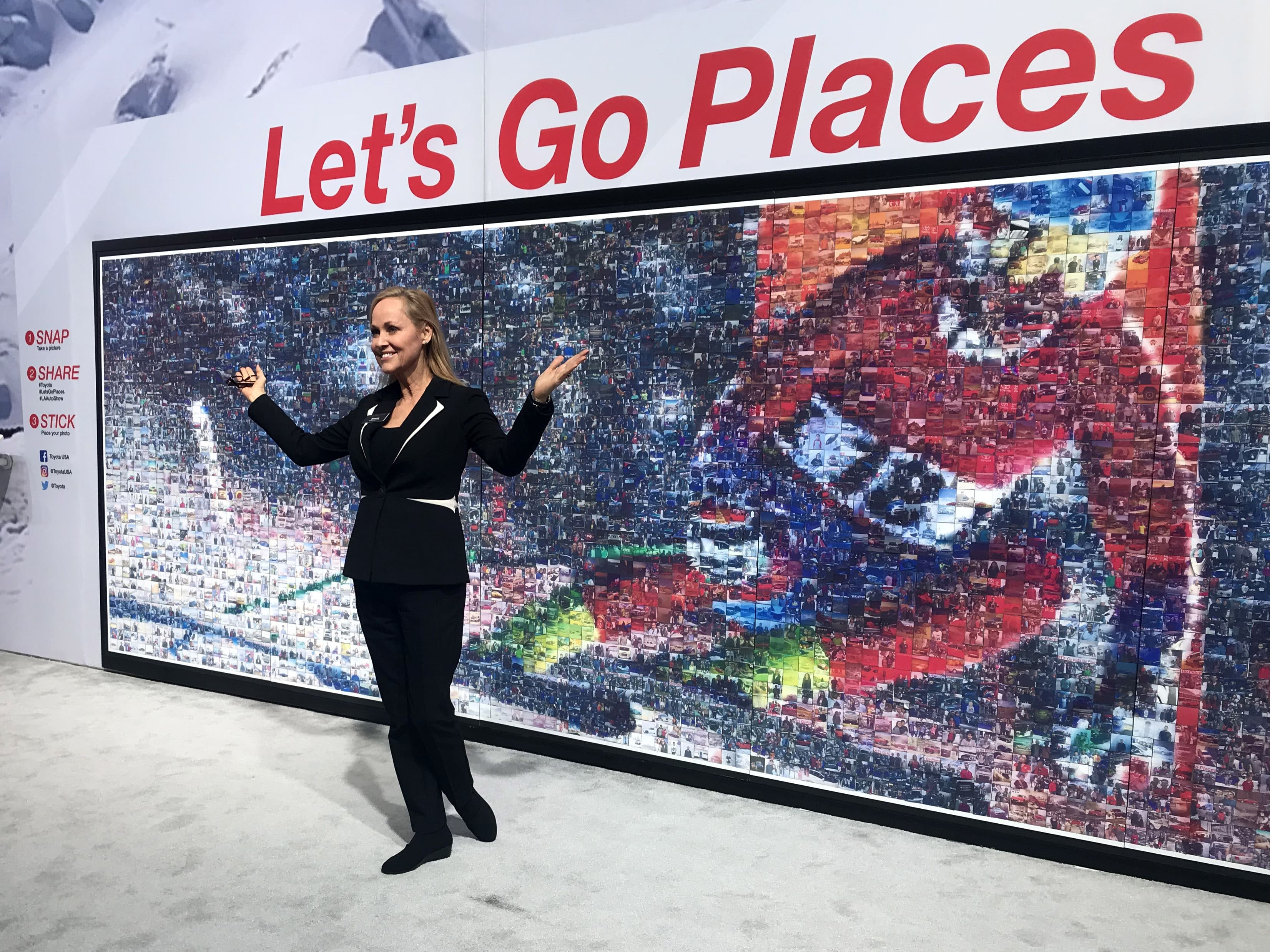 Guest posing in front of the Toyota photo mosaic at the LA Auto Show
