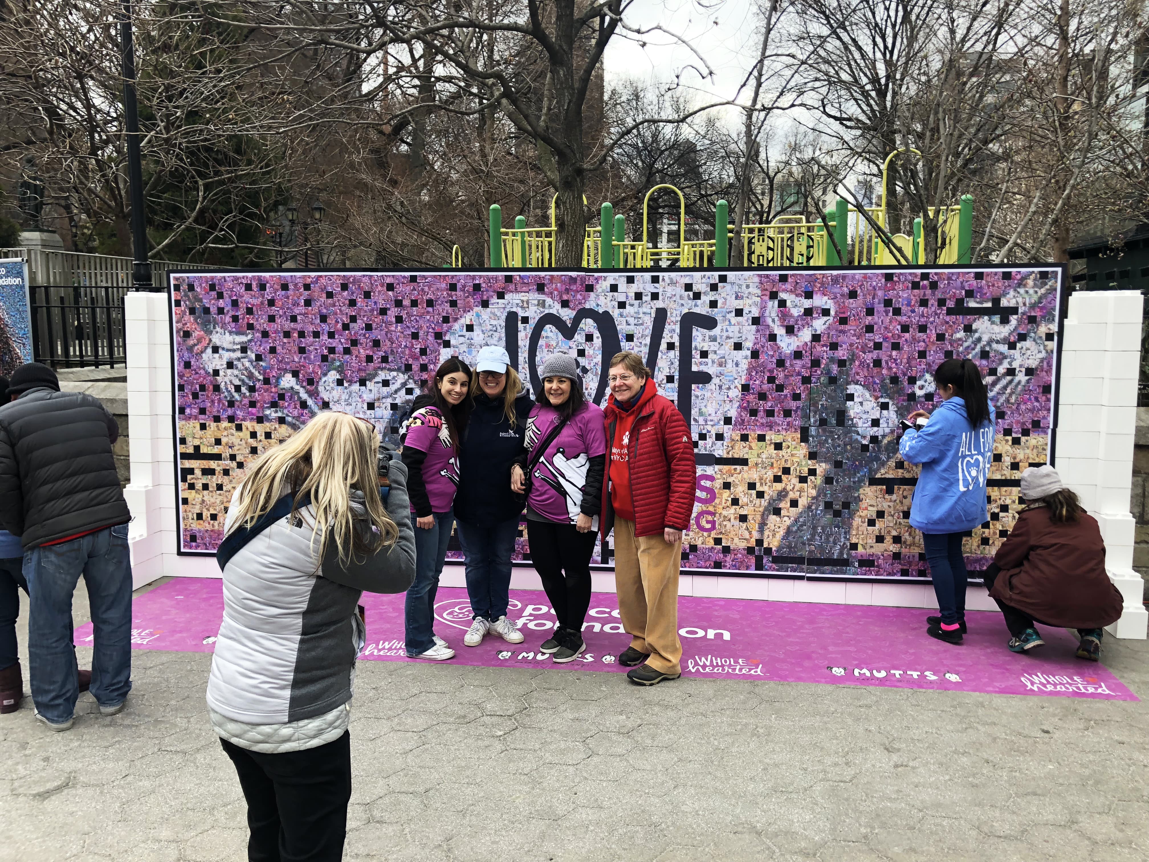 Participants posing in front of the mosaic to be included in the final display