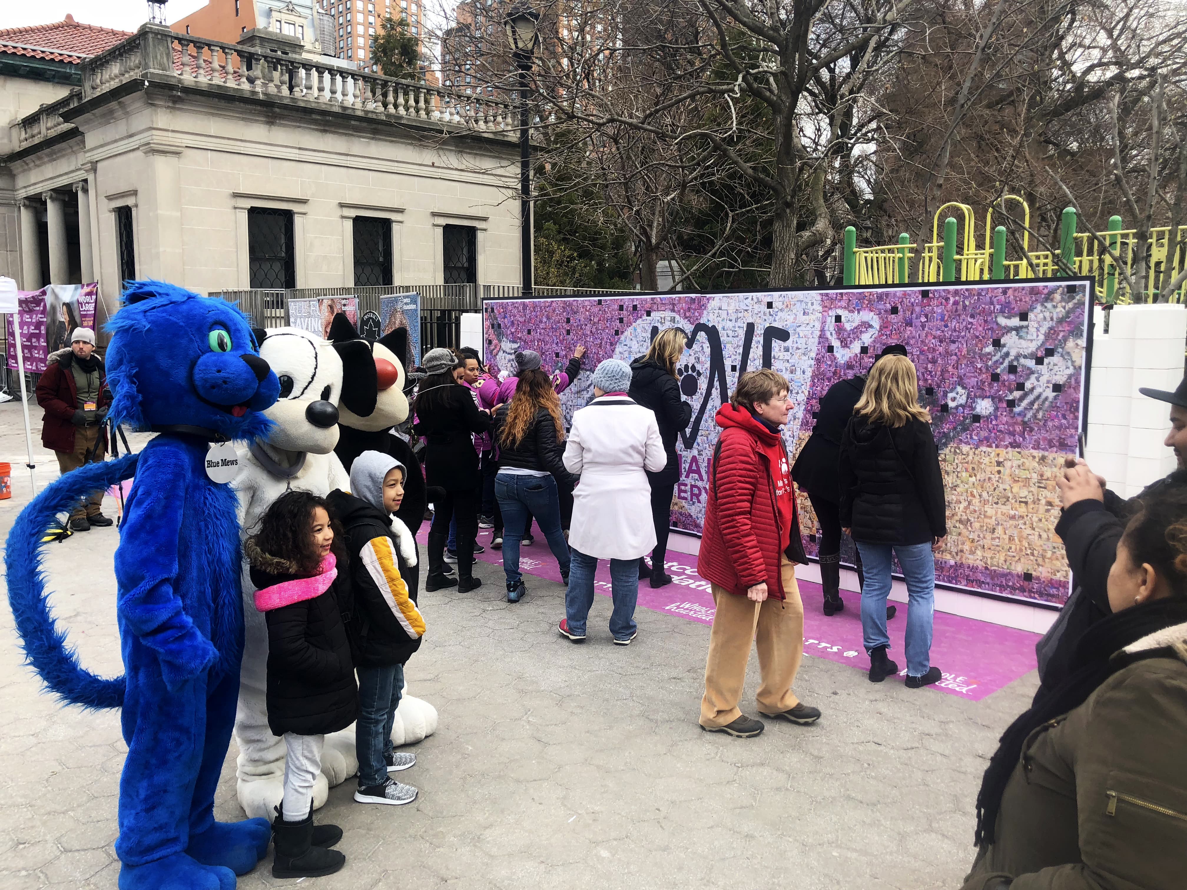 Guests taking photos with mascots to create their own mosaic tile
