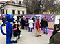 Guests taking photos with mascots to generate personalized mosaic tiles