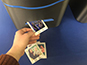Guest retrieving their printed photo tile from live print mosaic printer