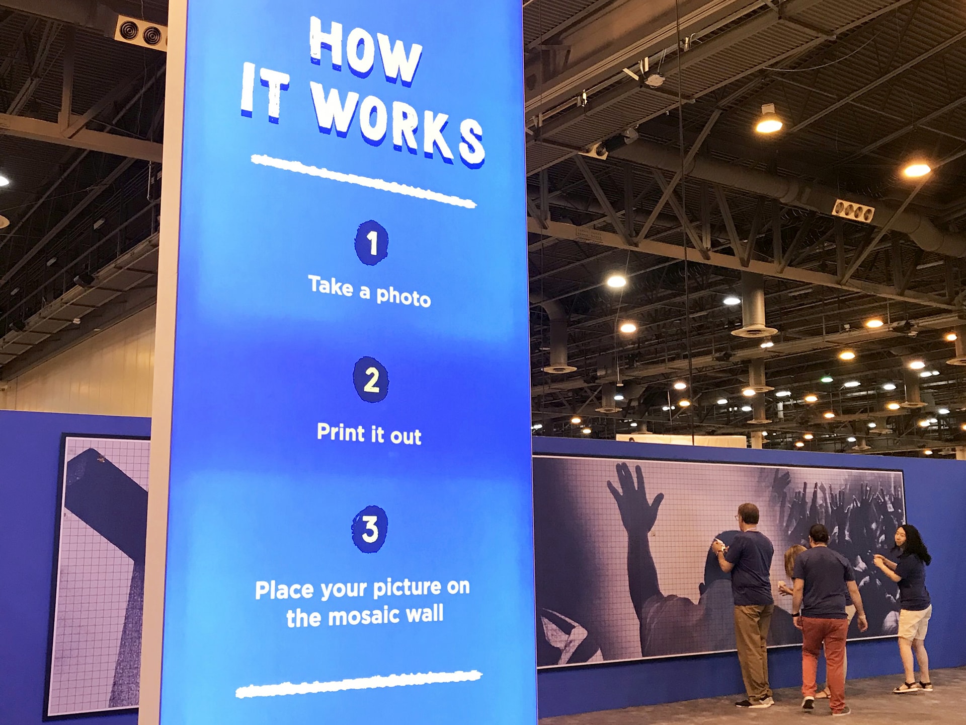 Wide shot of the Live Print Mosaic during setup inside a large event venue.