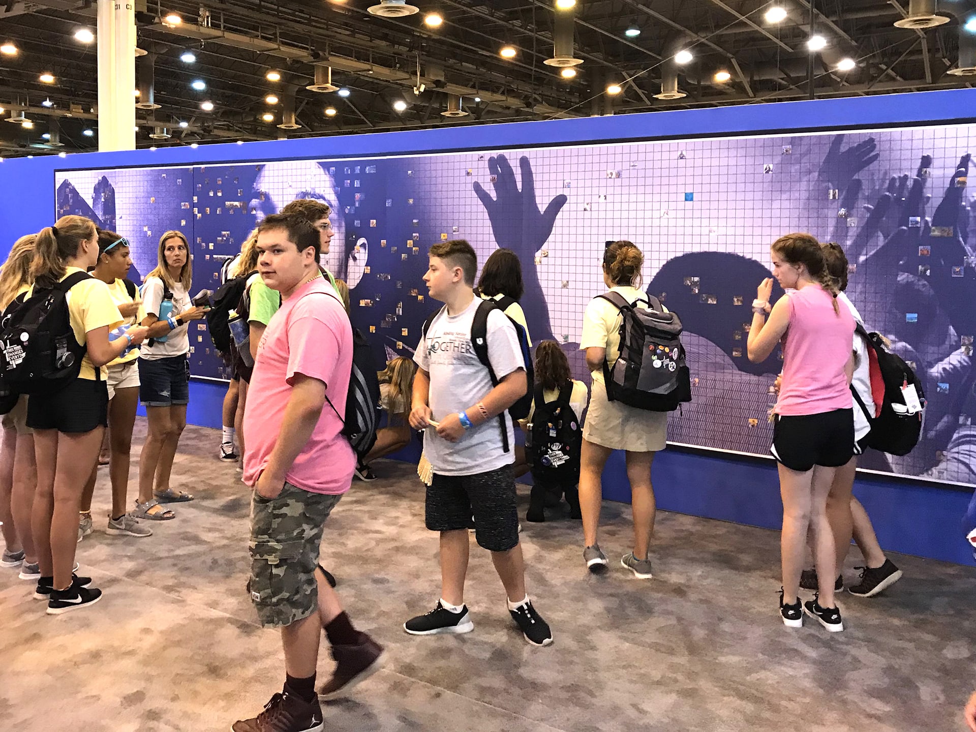 A photo of the event floor, with multiple guests exploring the mosaic.