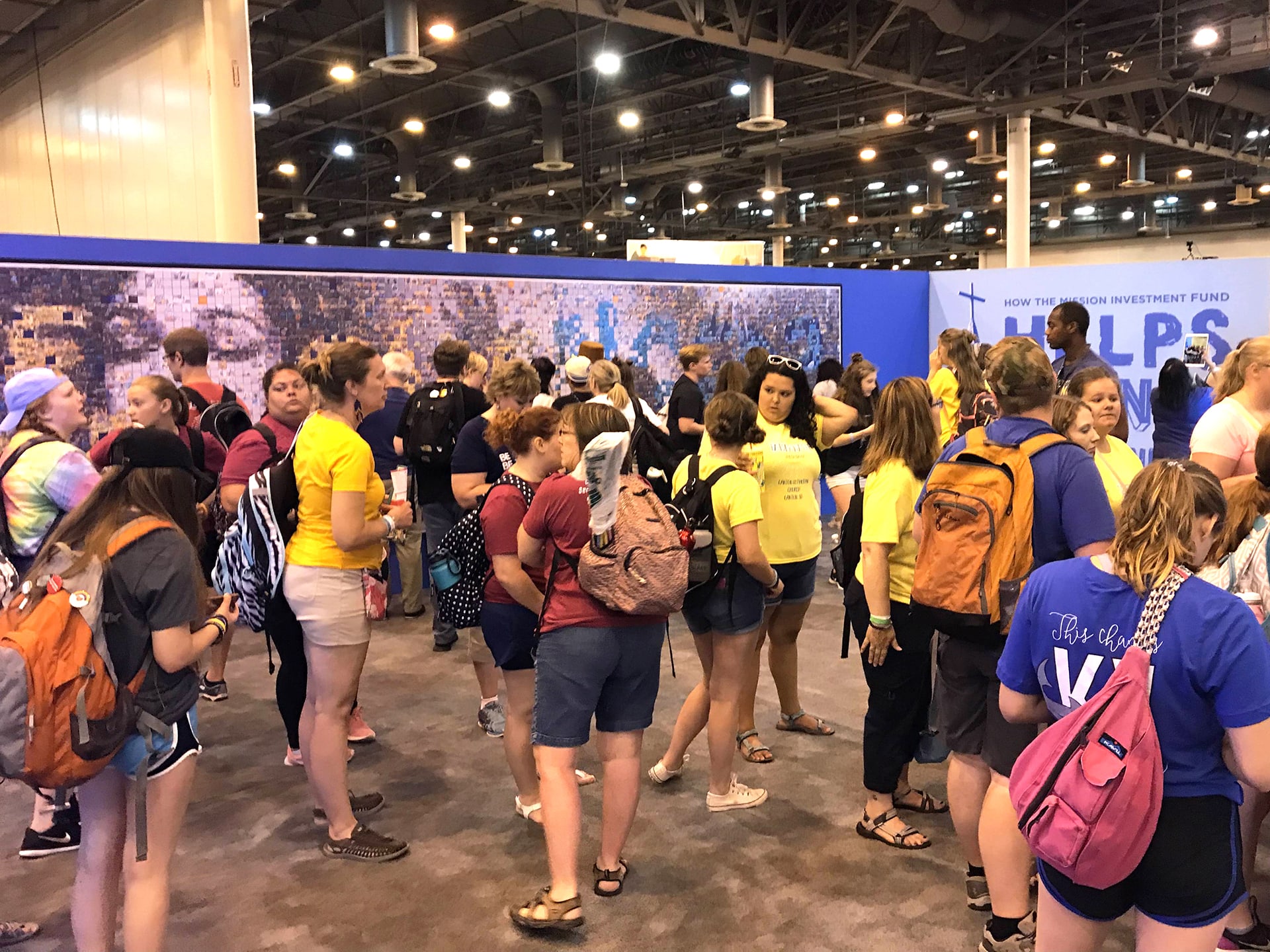 A busy event floor filled with guests eager to participate in the mosaic.