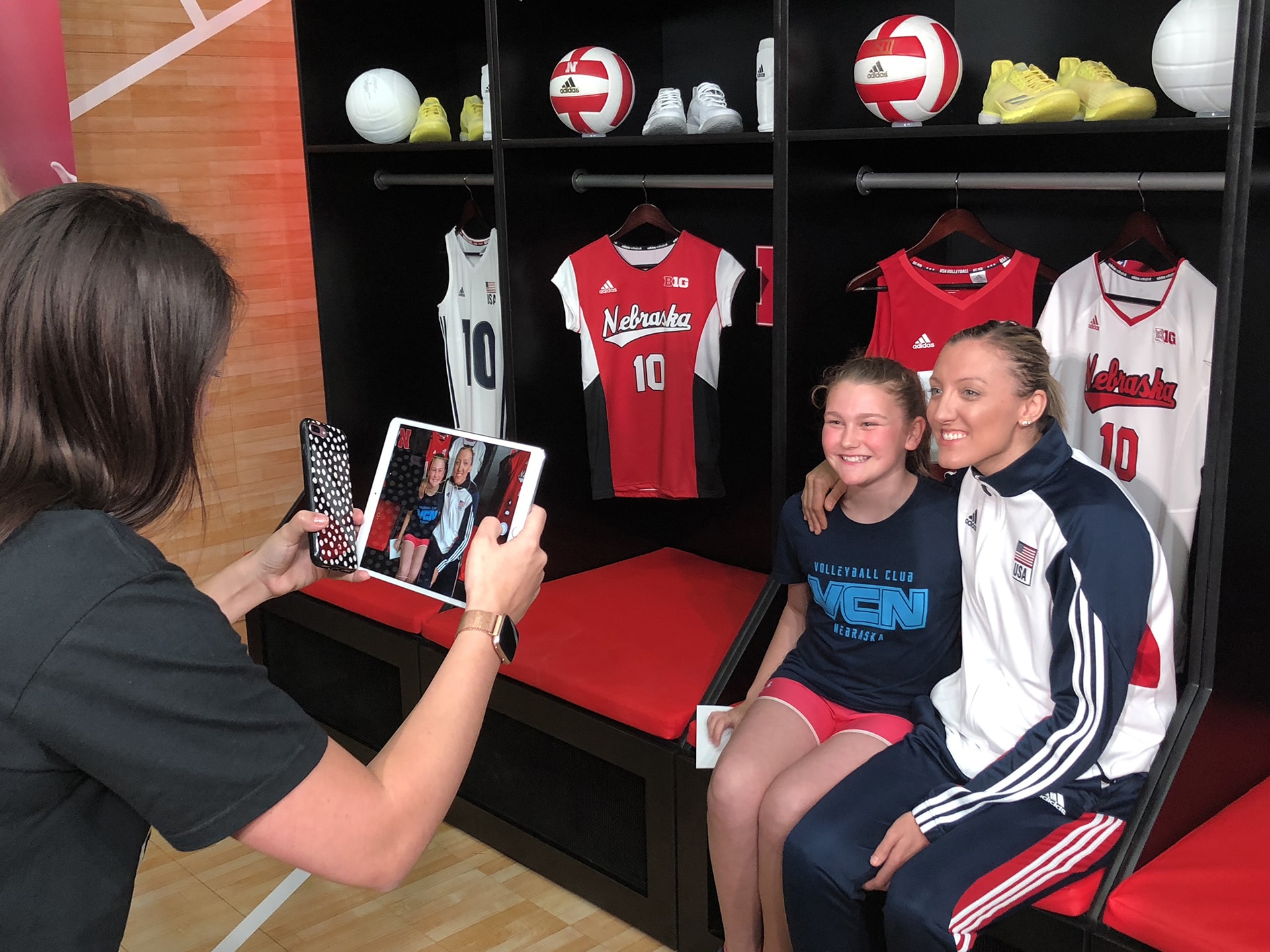 Team USA volleyball player Jordan Larson in front of the Adidas mosaic wall.
