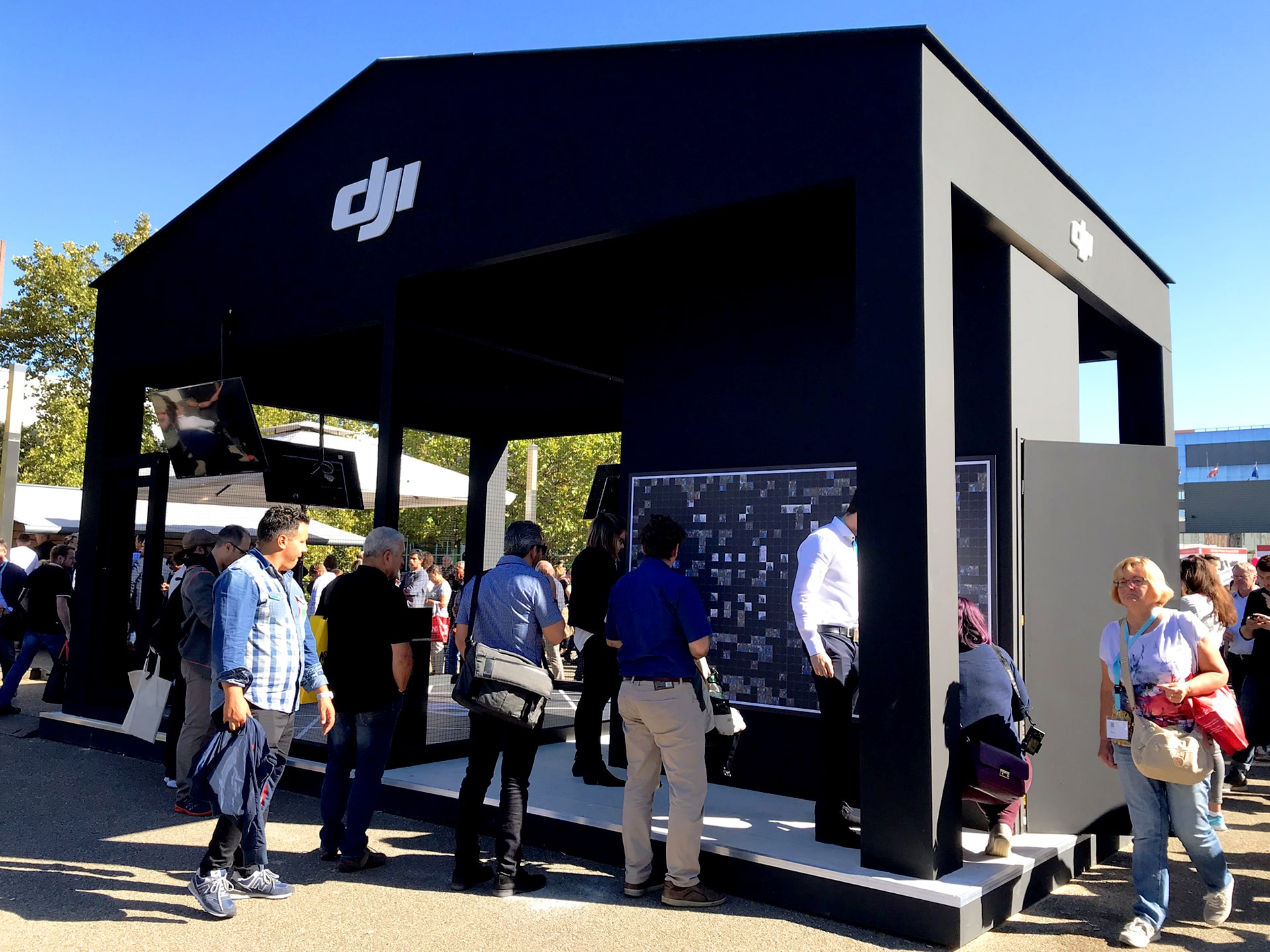 The DJI outdoor booth setup at Photokina featuring the Live Print Mosaic experience.