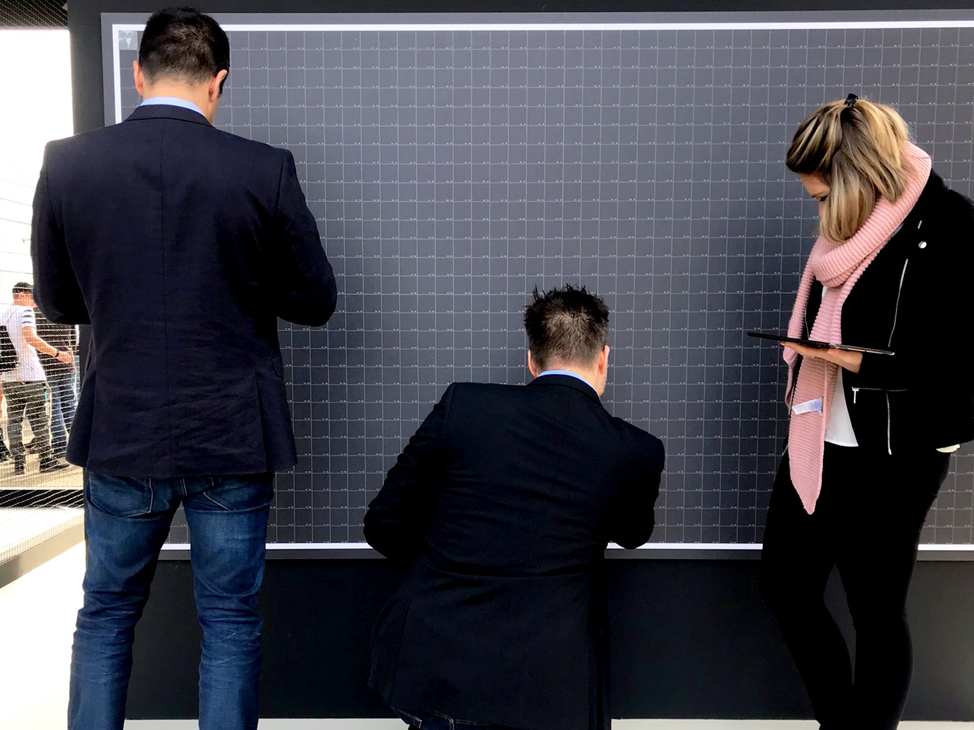 Guests placing the first printed photos onto the DJI mosaic at Photokina.