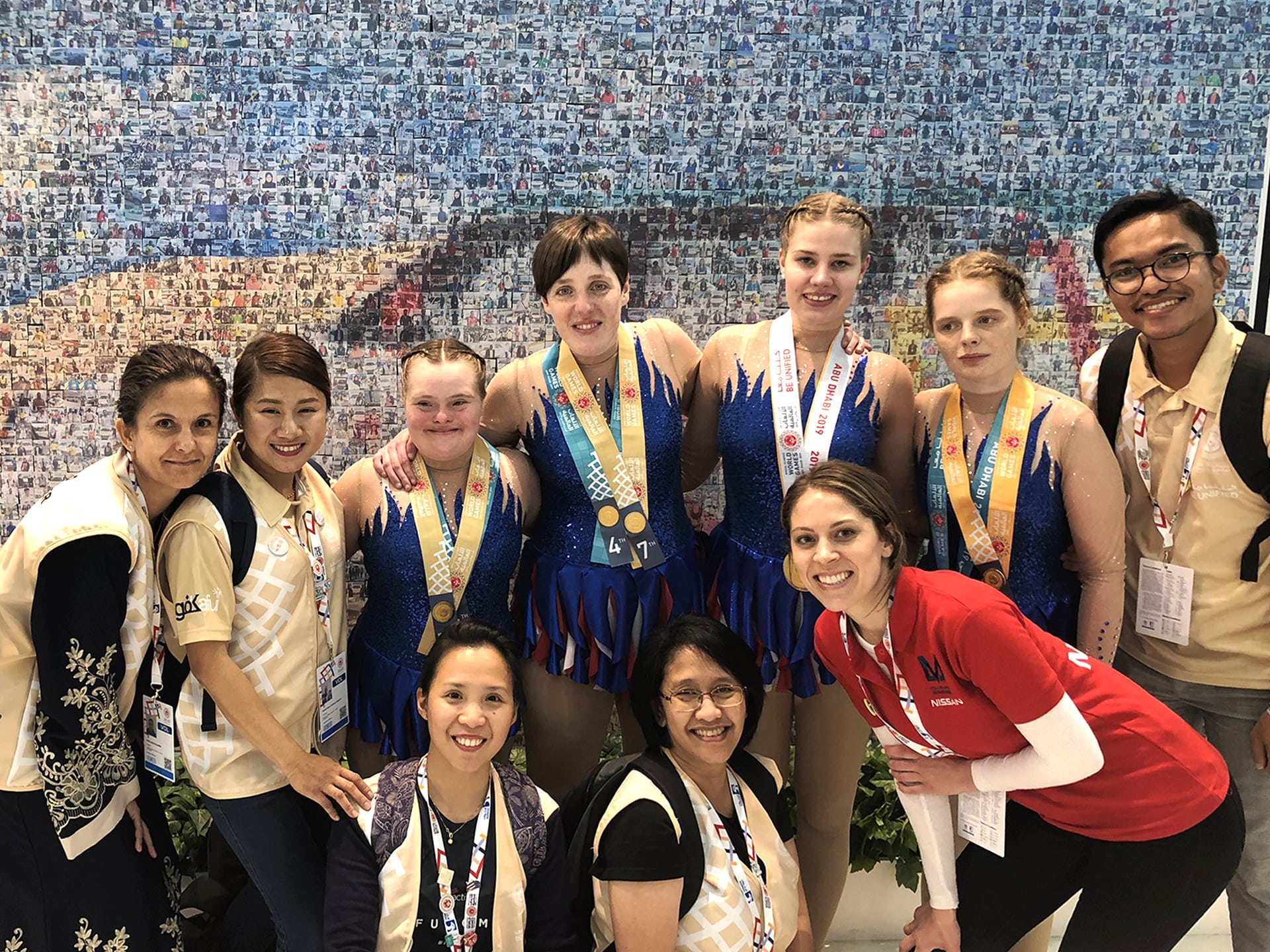 A group of athletes celebrates in front of the live mosaic activation at the 2019 Special Olympics World Games.