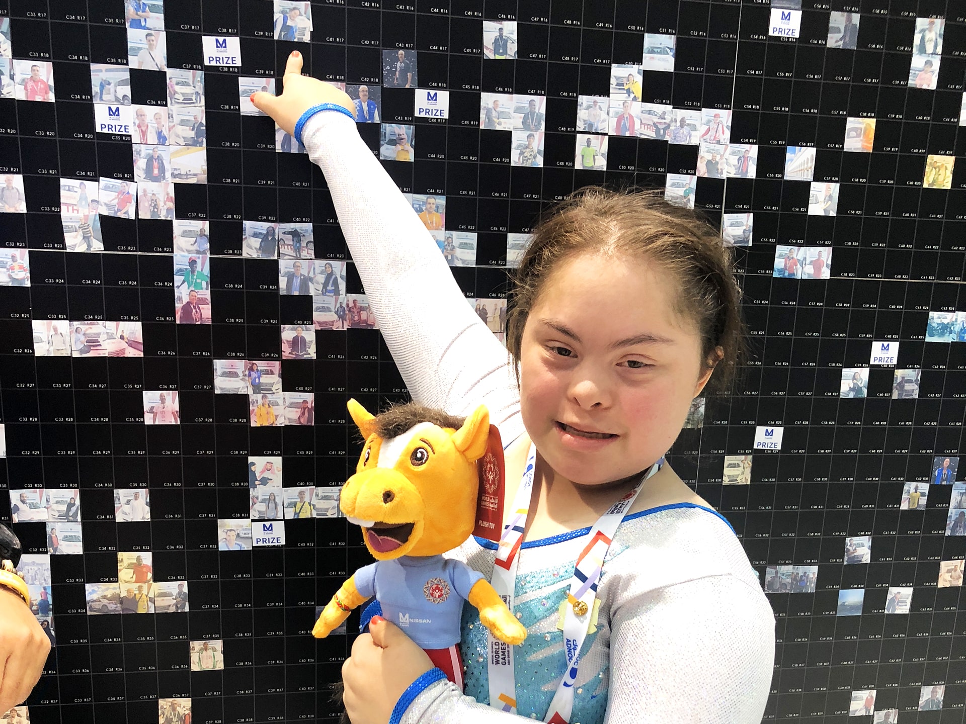 A participant points out their photo on the mosaic display at the 2019 Special Olympics World Games.