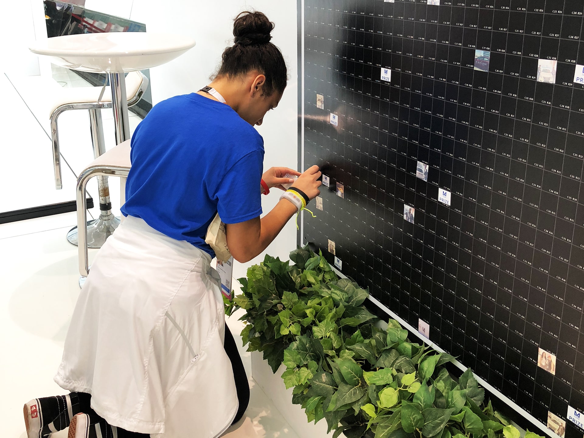 An athlete places their printed photo onto the mosaic wall during the 2019 Special Olympics World Games.