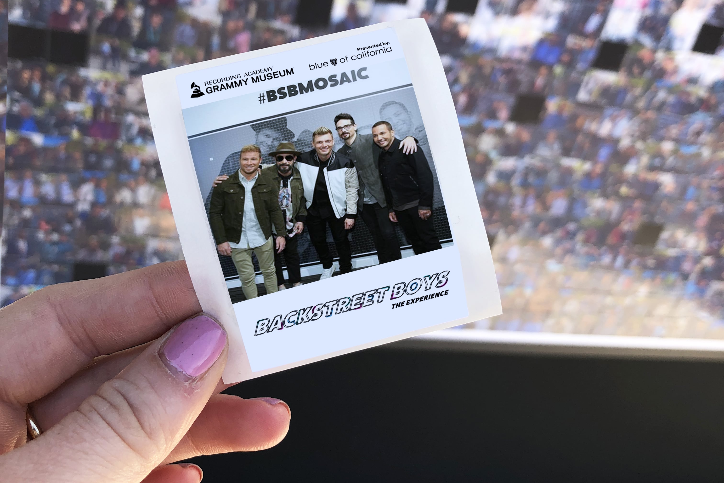 Backstreet Boys: The Experience – Guest holding a printed photo takeaway from the mosaic experience.