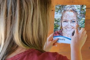 Woman looking at a personalized photo mosaic of herself