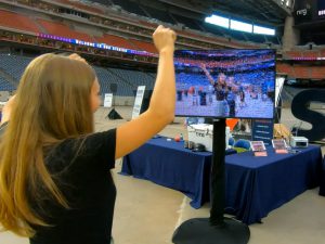 Person at an event posing in front of a Mirror Mosaic, watching as it updates in real-time