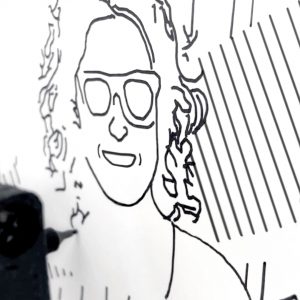 A close-up shot of a SketchBot sketching a woman's portrait.