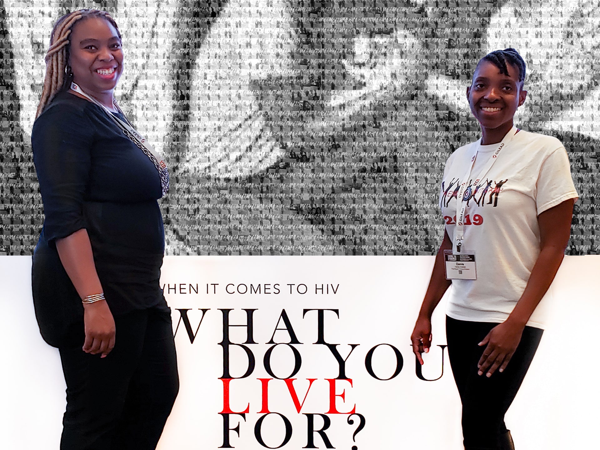 Two women posing with the completed photo mosaic wall as backdrop