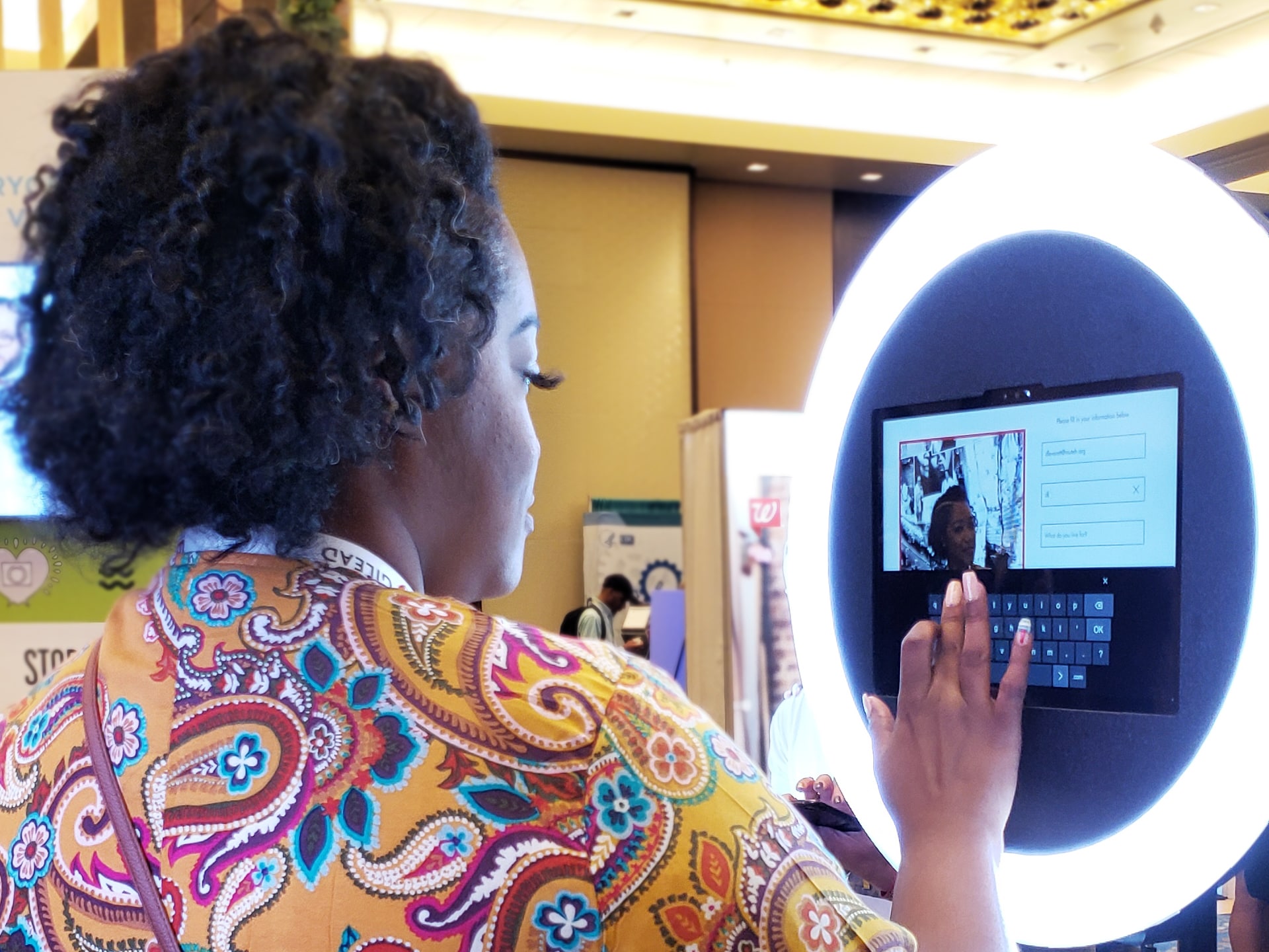 Guest entering information at iPad kiosk to receive branded mosaic follow-up email