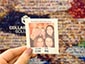 Detailed view of a printed photo tile in front of the mosaic display