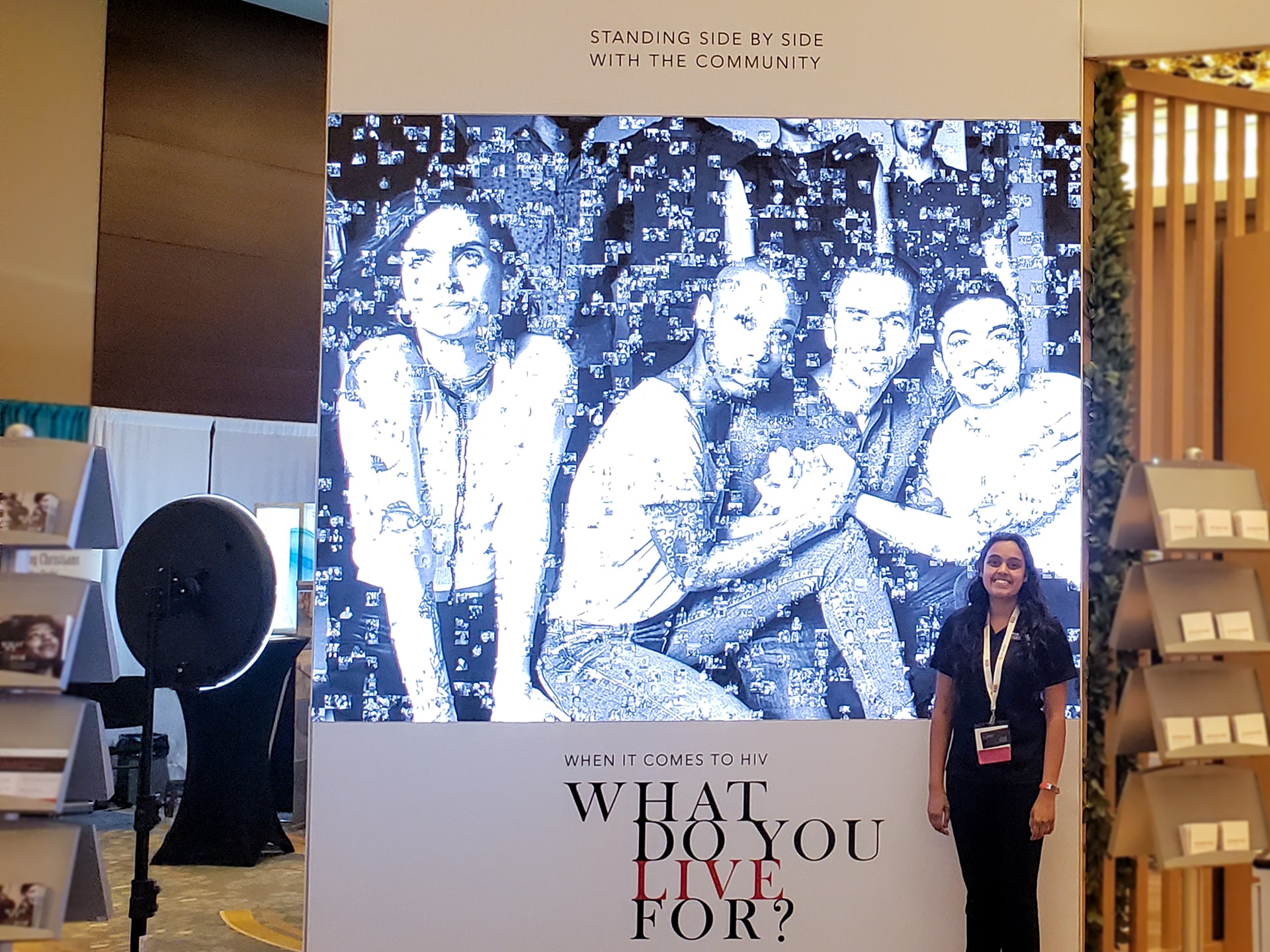 Event attendee standing in front of the digital photo mosaic display