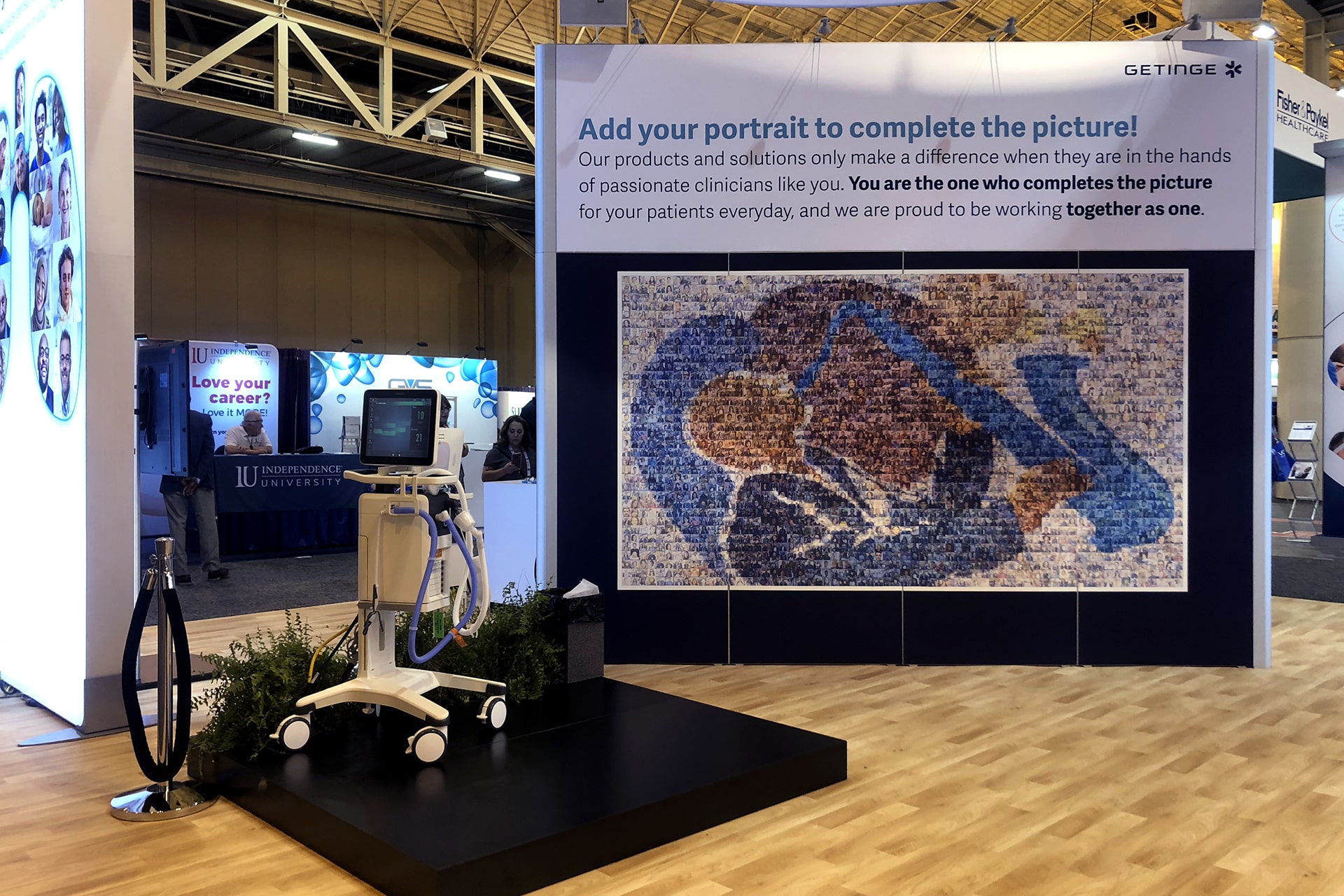 Wide shot of the Picture Mosaics booth at AARC 2019, featuring the mosaic wall and participants contributing photos