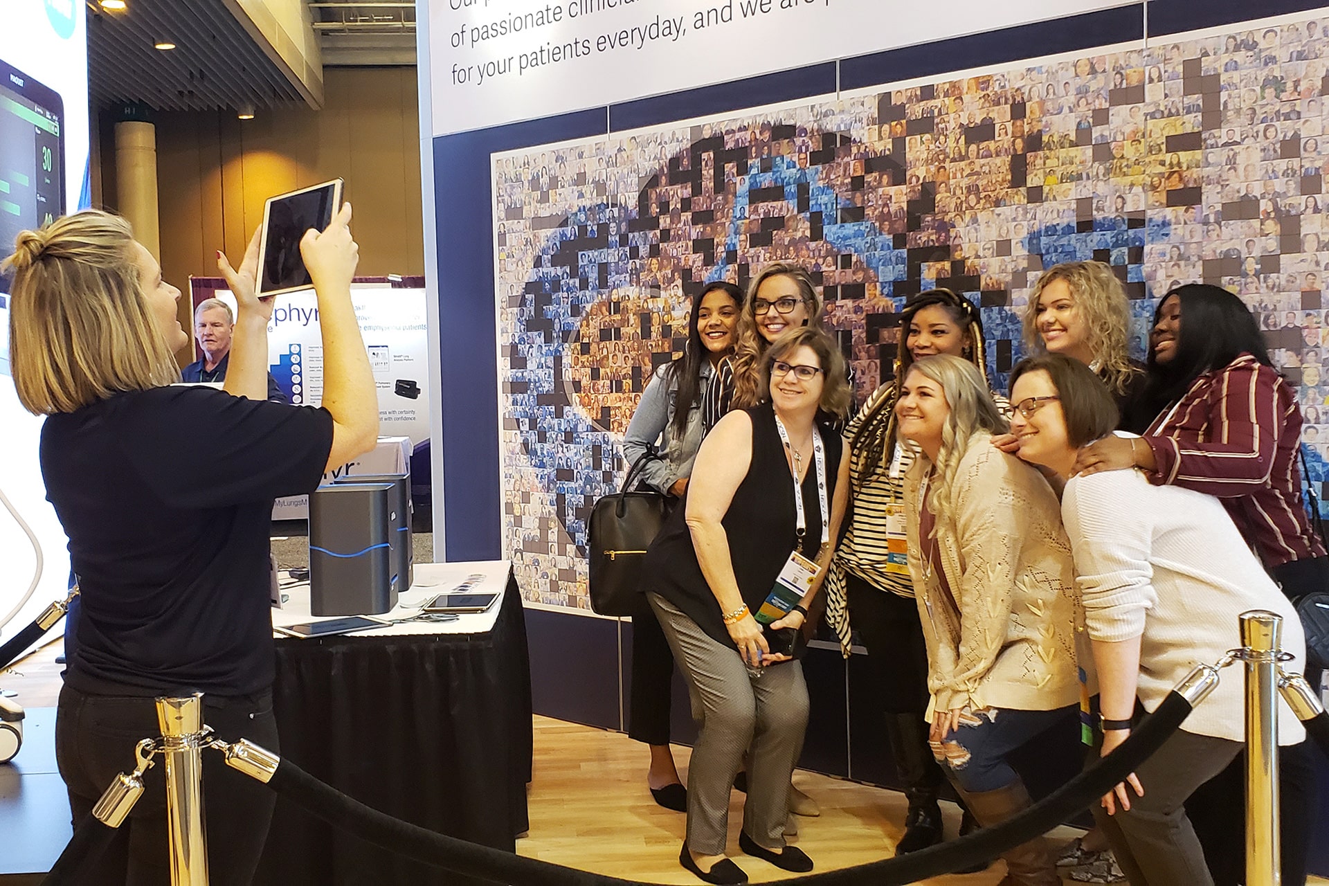Group photo of participants at the Live Print Mosaic event at AARC 2019, showcasing guests engaging with the mosaic wall