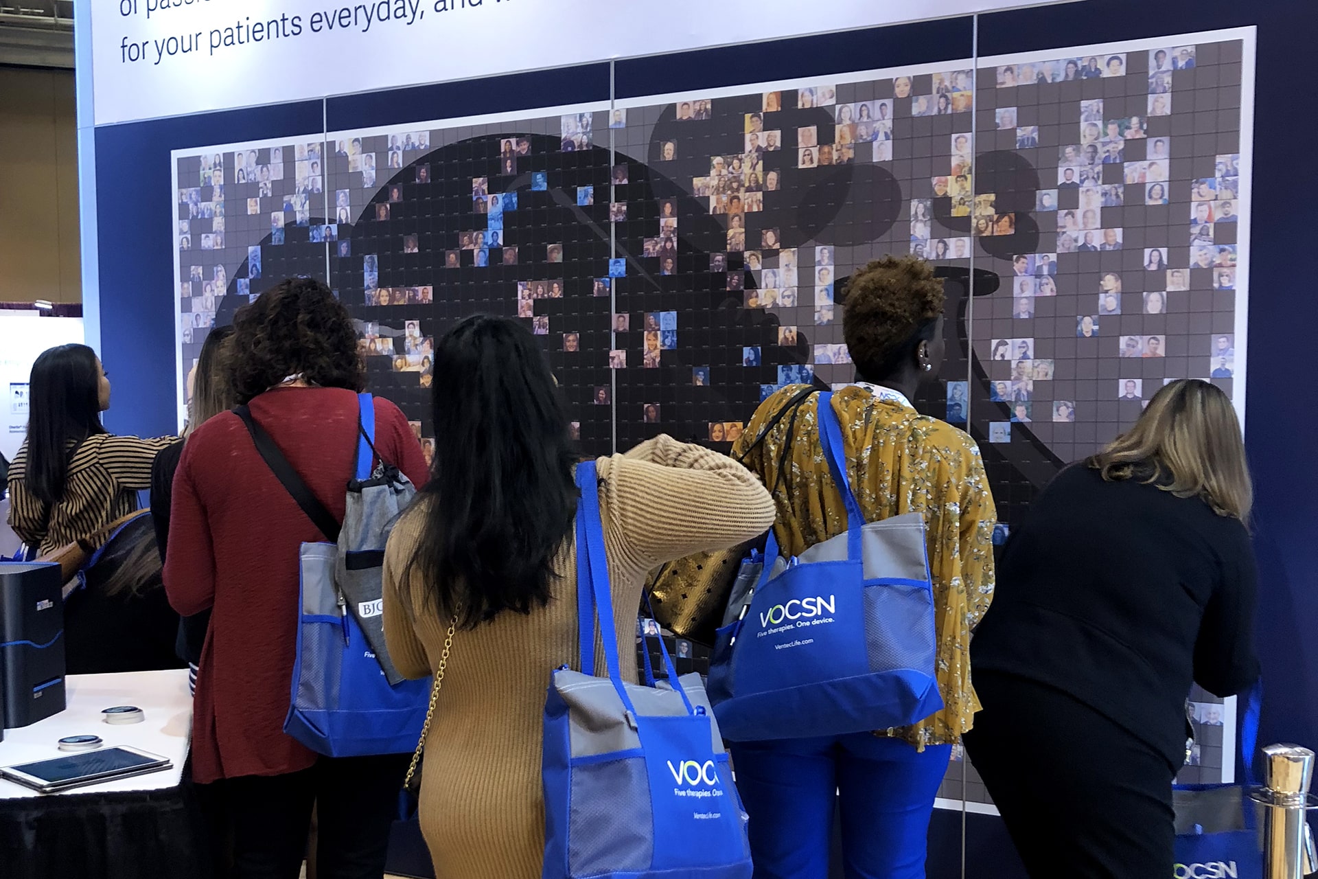Another group photo from the Live Print Mosaic event at AARC 2019, capturing participants smiling while interacting with the mosaic