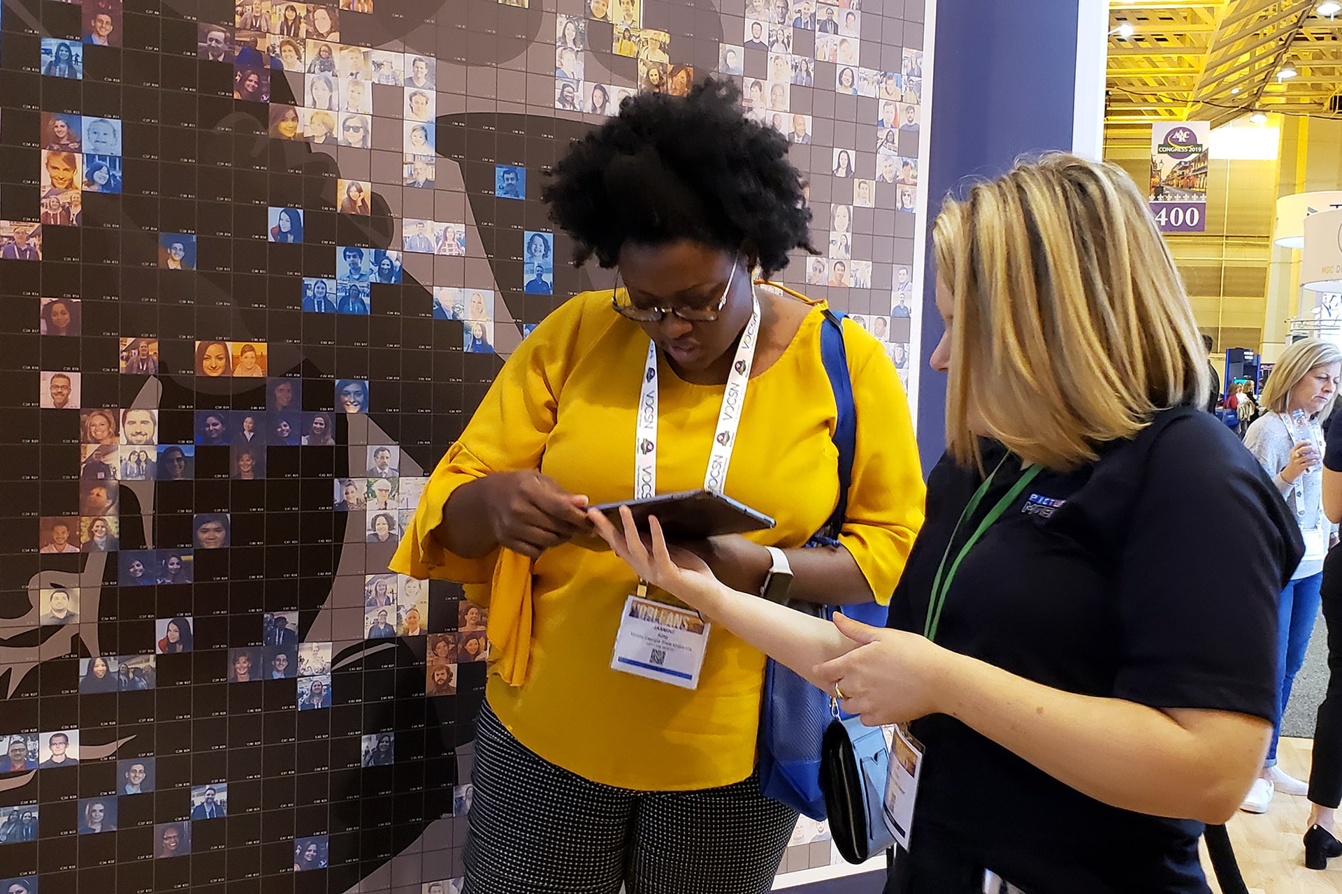 Close-up of a participant using an iPad to select photos for the Live Print Mosaic during the AARC 2019 event