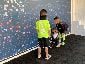 Young fans excitedly posing in front of the Super Bowl LV Live Print Mosaic.