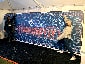 A partially completed Super Bowl LV mosaic wall with new photos still being added.