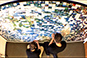 Overhead view of two participants adding their tiles to the mosaic