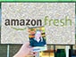 A guest holding their branded 4x6 photo takeaway from the Amazon Fresh Live Digital Mosaic experience.